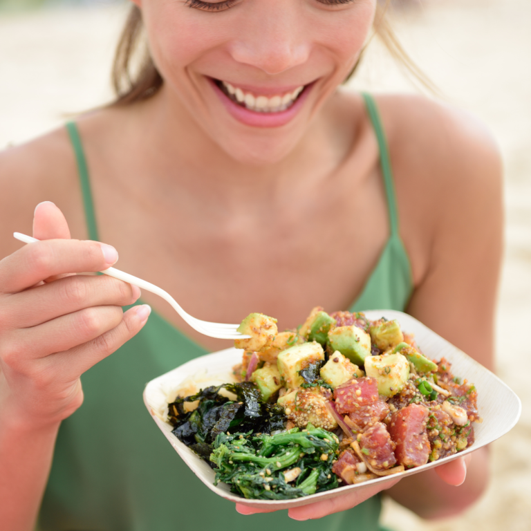 Woman eating a bowl of street food