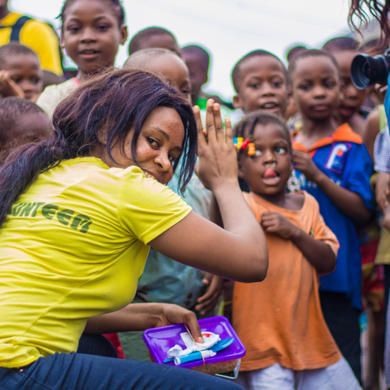 Woman volunteering with African children