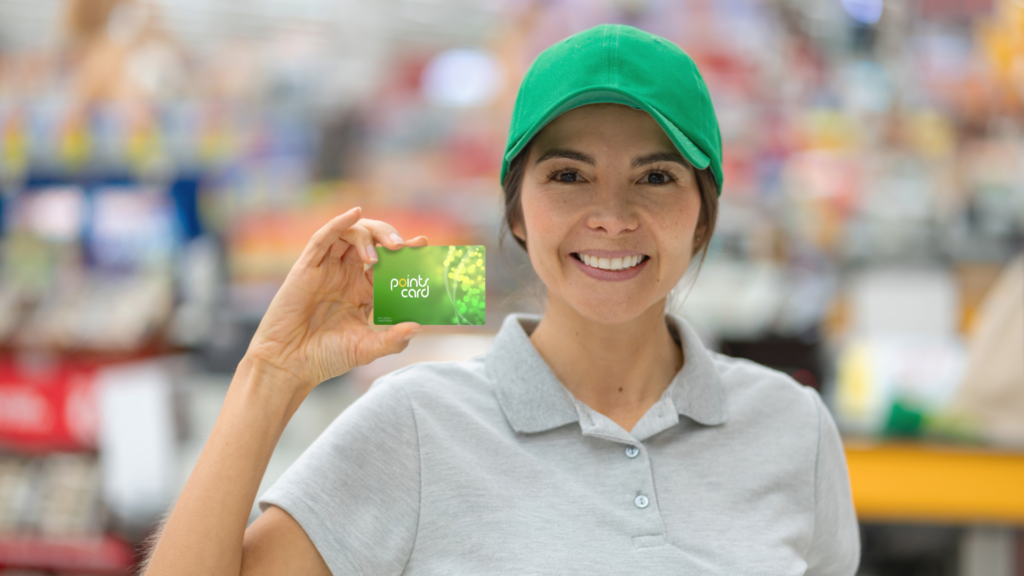 woman employee holding a loyality card in a store