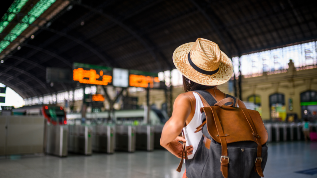 woman looking at a travel board at a train station