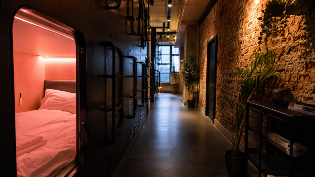 Modern pod-style hotel room with mood lighting in a European capsule hotel