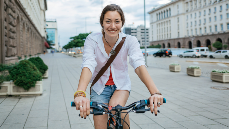 woman riding a bike in a city